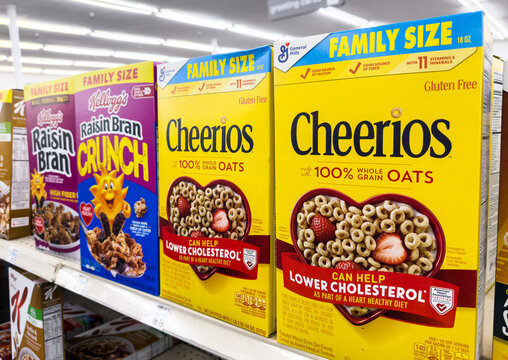 box of General Mills Brand Whole Grain Oats Cheerios Family size in a supermarket aisle	
