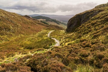 An autumn hike, along Ben A'an trail in Scotland highlands, towards Loch Achray in Callander, UK