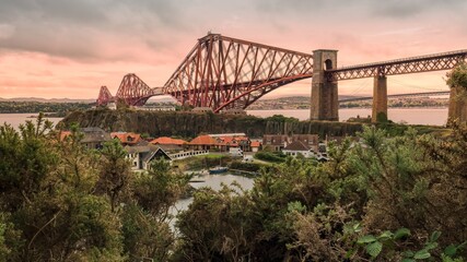 A hike along Fife Coastal Path with view of Forth Bridge overlooking the inlet from Inverkeithing, UK