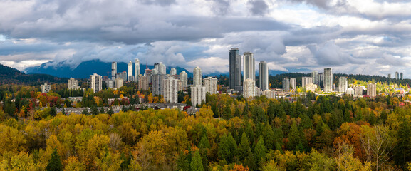 Fototapeta premium Autumn City Skyline Over Burnaby Forests and Mountains in Vancouver Metro, British Columbia, Canada