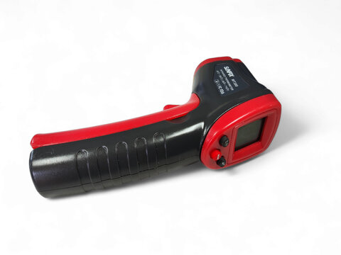 Balikpapan-Indonesia 02/02/2025 Red and black infrared thermometer or temperature gun with an LCD screen and trigger grip, isolated on a bright white background. Non-contact measurement tool.