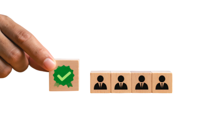 Hand placing a "verified" block beside others with silhouetted figures. Black background