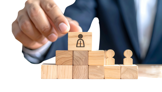 A hand places a person icon block atop a wooden pyramid, symbolizing hierarchy