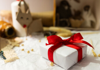 Homemade christmas gift with red ribbon on crumpled paper