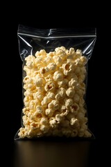 Freshly popped popcorn in clear bag ready for movie night or snack time, a delicious treat for any...