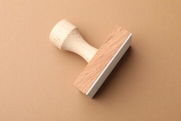 One wooden stamp on brown background, top view