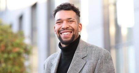 Smiling man in suit on city street