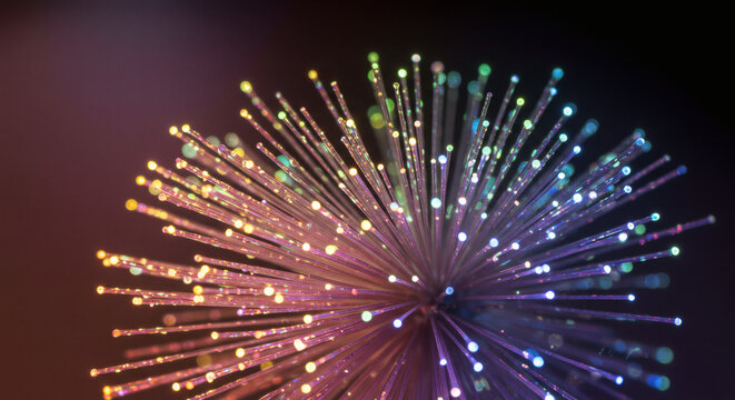 Vibrant burst of glowing fiber optic strands in a mesmerizing abstract visualization of data and network communication