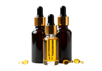 Three amber glass dropper bottles with golden caps isolated on transparent background