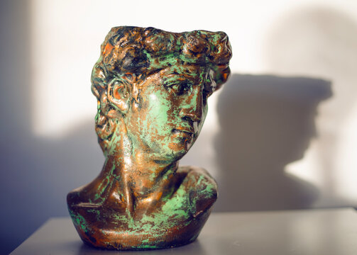 Bust of the Greek god Dionysus with gilding and patina texture