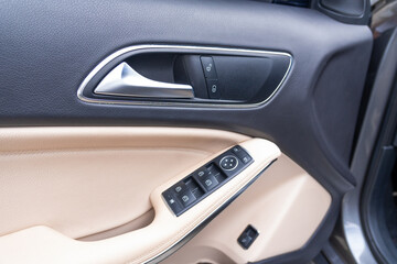 Close-up photograph of the control knob and lock of a modern vehicle door