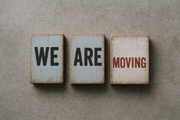 Moving announcement message on wooden blocks, relocation concept, business transfer and change of address