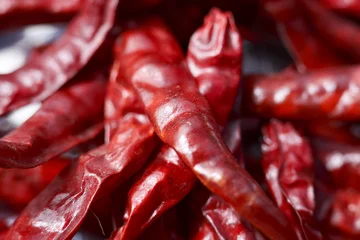 Acrylglasbilder Scharfe Chili-pfeffer Vibrant close up of dried red chili pepper. This intense and hot spicy ingredient for cooking food has pungent flavor. textured and natural background for any cuisine  © CoreRock