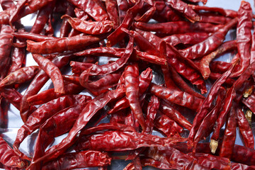 Vibrant close up background of dried red chili peppers. pile of hot and spicy ingredients for cooking traditional food, showcasing intense flavor and aroma for any meal