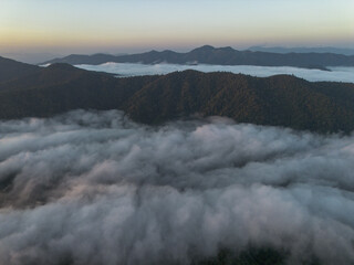 Serene aerial view of mountain landscape at sunrise. sea of cloud and fog fills valley, creating breathtaking and tranquil scenic vista of nature beauty