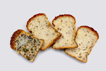 Sliced multigrain bread topped with pumpkin seeds, sunflower seeds, sesame, and black sesame.