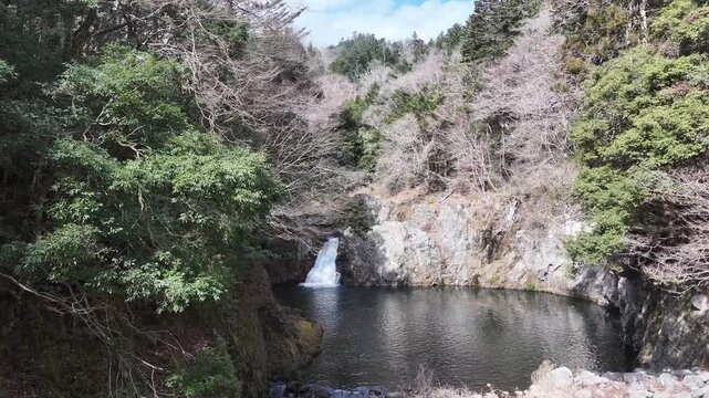 A stunning aerial journey over Kido River&rsquo;s grand waterfall in Fukushima. The drone flies upstream toward the roaring falls, revealing sparkling water contrasts under the morning sun,