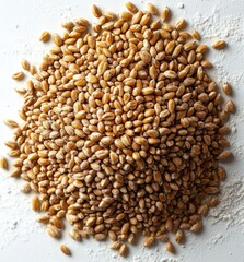 Obraz premium close-up of a pile of wheat grains on a white surface with some scattered wheat and flour around, highlighting texture and natural color