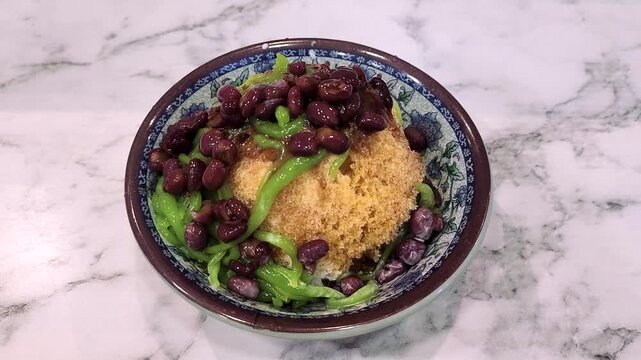 Cendol is a Malaysian dessert made of shaved ice, coconut milk, green pandan jelly noodles, and sweet dark brown sugar syrup (Melaka Sugar).
