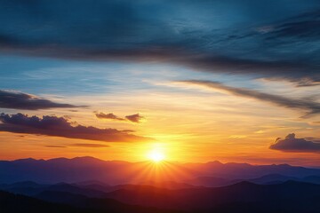 Vibrant sunset over layered mountain ranges with dramatic clouds and radiant sun rays illuminating the sky in warm and cool tones