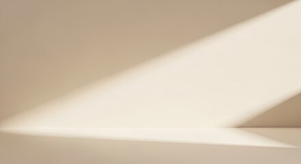 Empty beige studio room with sunlight streaming in.