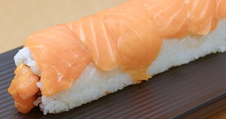 Delicious Salmon Sushi Roll on a Dark Plate