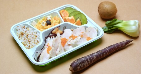 Healthy Meal Prep Container with Chicken, Rice, Fruits, and Vegetables