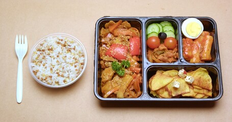 Korean-inspired Bento Box Meal with Garlic Rice and Side Dishes