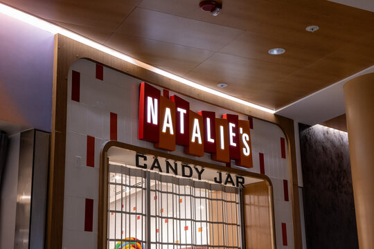 Seattle, Washington \ USA - 14 November 2024:  Closed Natalie's Candy Jar shop with illuminated neon sign at Seattle-Tacoma International Airport