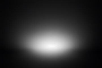 Fototapeta premium Abstract black and white gradient background with a soft, blurred light source.