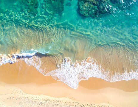 Aerial view of a beach with clear turquoise water meeting golden sand - Powered by Adobe
