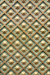 Close up of 3D carving panel in random diamond and star pattern. Finished in gold metallic color. Suitable for wall decoration. Seamless background texture.
