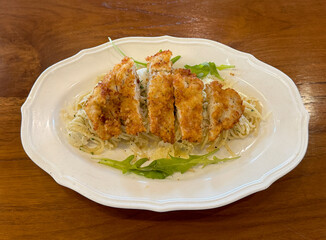 Close up of chicken alfredo pasta with cream and herbs. Italian western food, served on a wooden table. Food photography.