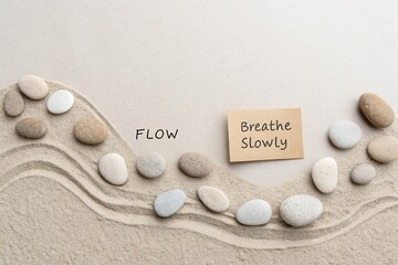 Minimal Pebbles Arranged in a Wave Shape on a Sand Surface