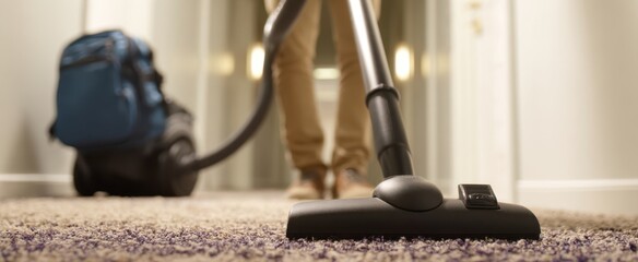 The Vacuum Cleaner in a Home Hallway Cleaning a Plush Carpet During Everyday Housekeeping