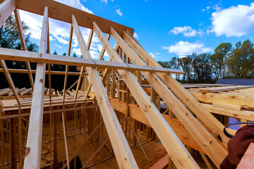 Wooden beams trusses form structure of house with joist installation
