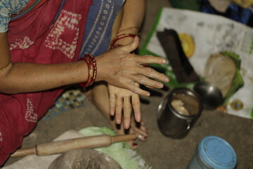 Traditional Indian cooking scene showing a woman shaping chapati dough, representing love, care, and the everyday rhythm of rural and urban Indian life.