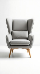 Modern light grey wingback armchair featuring a sleek design, matching lumbar cushion, and exposed wooden tapered legs. 