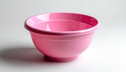 A Close Up Studio Shot of a Shiny Pink Plastic Mixing Bowl with a Wide Rim and a Solid Base on a White Background