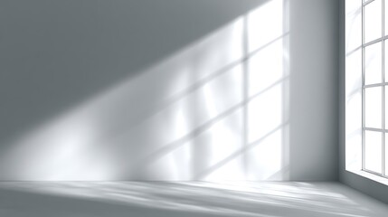 Empty gray room interior with sunlit wall from window creating shadow patterns