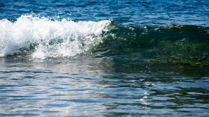Fototapeta premium Rolling sea waves movement. Wave background. Soft sea waves. Blue sea waves reflect sunlight. Abstract ocean texture.