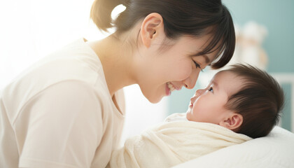 赤ちゃんと顔を寄せ合う若い母親　白色基調の柔らかな日が差す背景