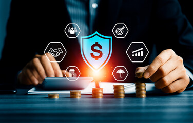 Shielding from financial risk and protecting investment concept with businessman stacking coins and digital shield icon, symbolizing financial security, wealth protection, and economic stability