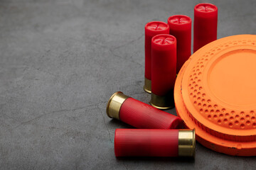 Clay shooting target and shotgun bullets on texture background ,Clay Pigeon target game