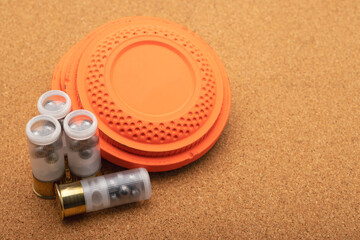 Clay shooting target and shotgun bullets on wooden background ,Clay Pigeon target game