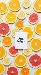 Sliced citrus fruits with a message to Stay bright