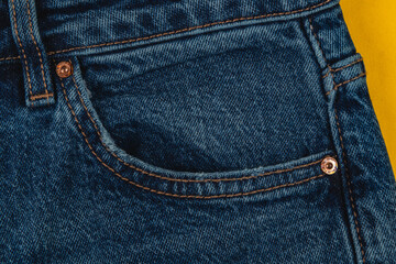 Denim jeans pocket detail with contrasting fabric background