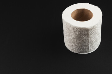 Roll of paper towel placed on a solid black background