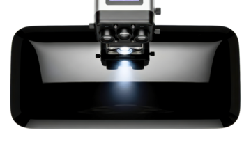 Modern digital microscope scanning a reflective black surface isolated on transparent background