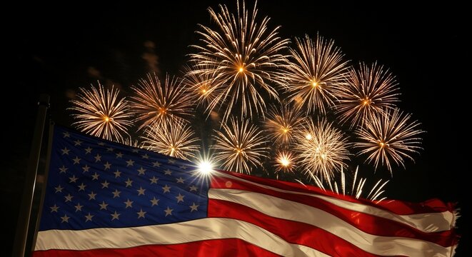 Spectacular Fourth of July fireworks illuminate the night sky above a waving American flag, celebrating national pride and freedom
